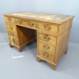 A mahogany and walnut twin pedestal writing desk, with tooled and embossed leather