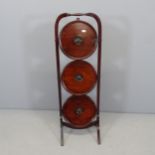 An antique mahogany three-tier folding cake stand. Height 91cm.