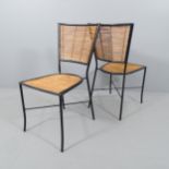 A set of four mid-century design chairs in black painted metal and bamboo.