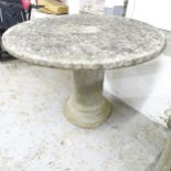 A weathered concrete two-section circular garden table on column base. 89x64cm.