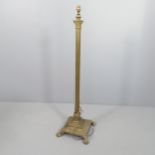 A brass Corinthian column standard lamp on platform base with claw and ball feet. Height to