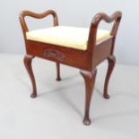 A 19th century mahogany and upholstered piano stool, with lifting seat and raised on tapered legs