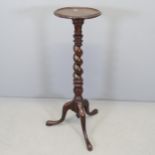 A mahogany torchere stand, with barley-twist column and tripod base. Height 92cm.