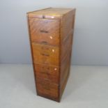 A vintage oak four drawer filing cabinet. 40x130x71cm.