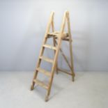 A vintage pine folding step ladder, with label for Drew Clark & Co. of London. Height overall 157cm.