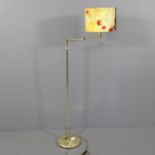 A modern brass standard lamp with swing arm. Height to bayonet 135cm.