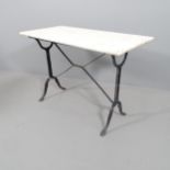 A rectangular marble topped garden table on cast iron base. 103x73x50cm.