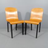 A pair of 1980s thermoformed bent ply chairs with ebonised legs.