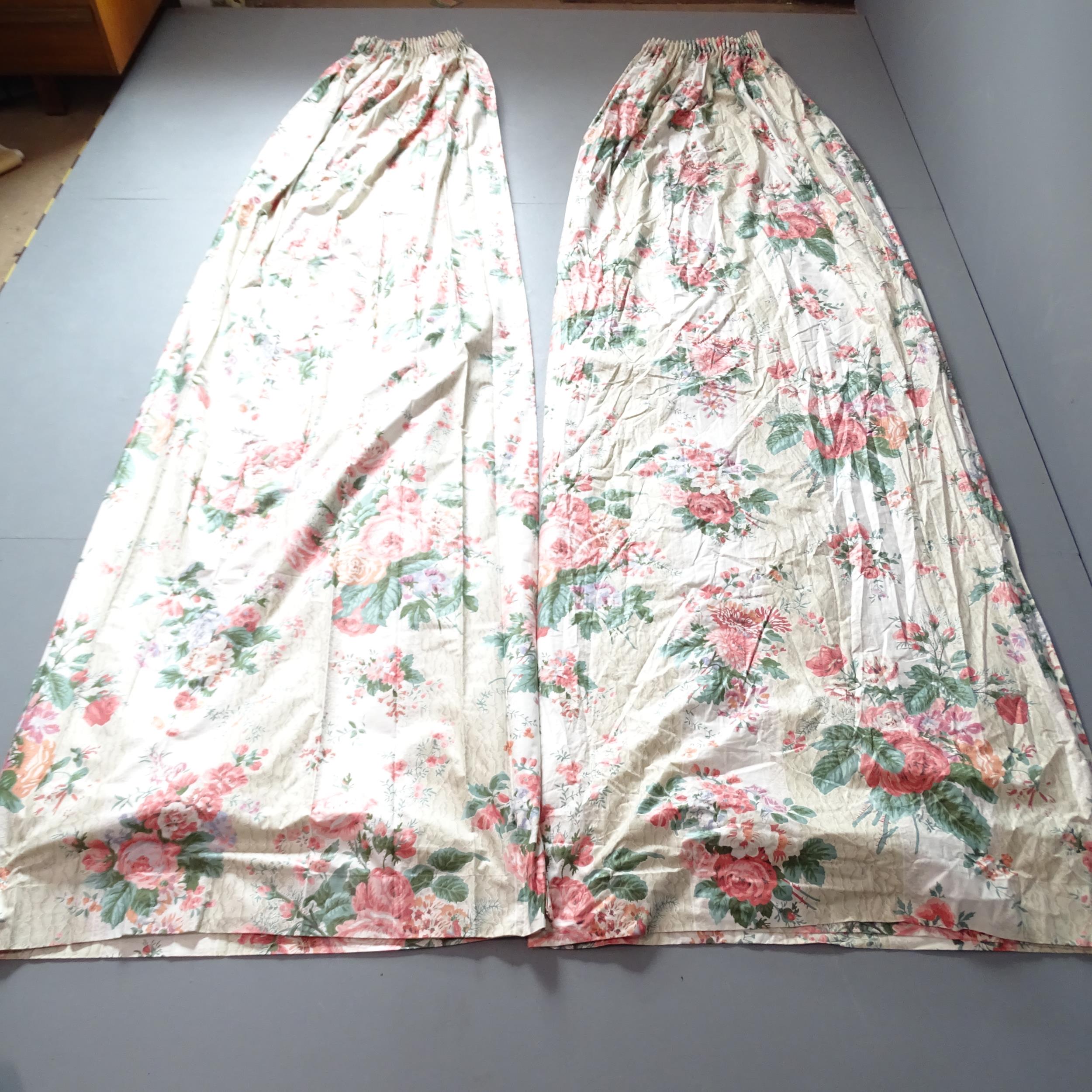 A pair of cream rose and fushia patterned lined curtains. Drop 300cm, width (top) 150cm, (base)