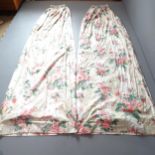 A pair of cream rose and fushia patterned lined curtains. Drop 300cm, width (top) 150cm, (base)