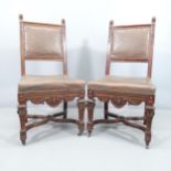 A pair of 19th century carved oak and leather upholstered Neo-Renaissance style dining chairs.