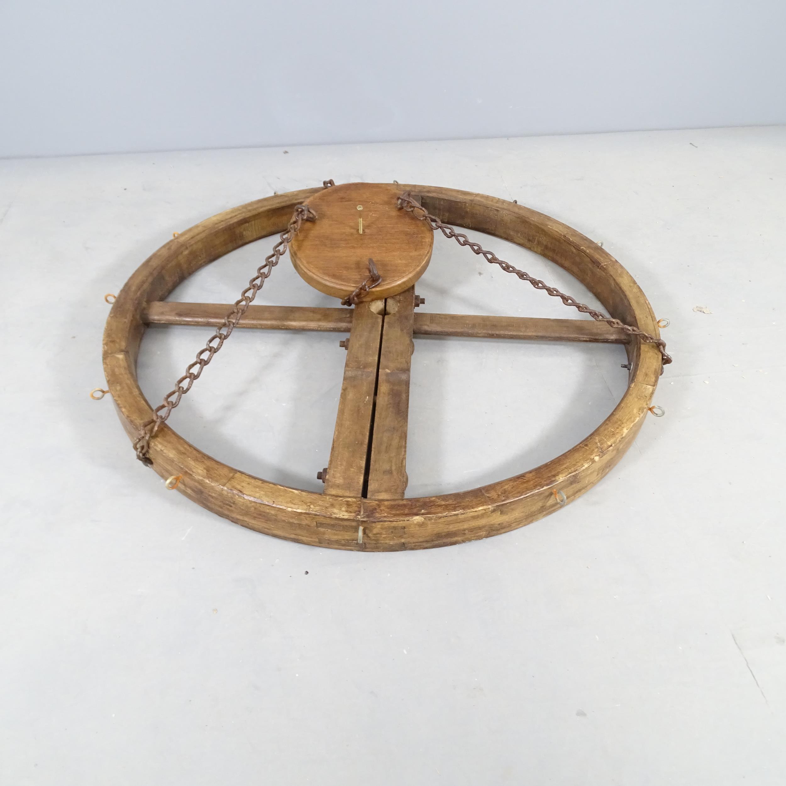 An oak circular hanging pan rack. Diameter 104cm.