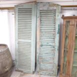 A pair of painted pine louvre shutters with metal brackets. Each - 61x208cm.