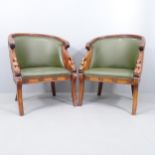 A pair of French Empire style walnut and mahogany studded faux-leather upholstered tub chairs.