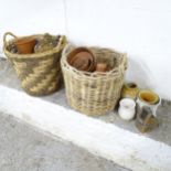 Two large wicker baskets (58x55cm) filled with an assortment of terracotta garden pots.