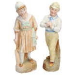 CRICKET INTEREST. A pair of hand-coloured continental bisque figures of a young boy holding a