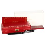 A Cartier black/steel-cased fountain pen, spare ink filler, original case and box, perfect condition