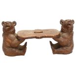 A 19th century Black Forest carved and stained wood stool, supported by 2 bears, length 42cm, height