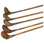 A group of 5 wood-shafted golf drivers