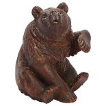 19th century Black Forest carved and stained wood bear design box, with hinged head, height 22cm