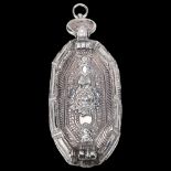 A South East Asian silver betel nut box, elongated octagonal form with relief embossed floral