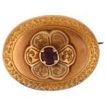A Victorian garnet memorial brooch, unmarked yellow metal closed-back settings, of oval form with
