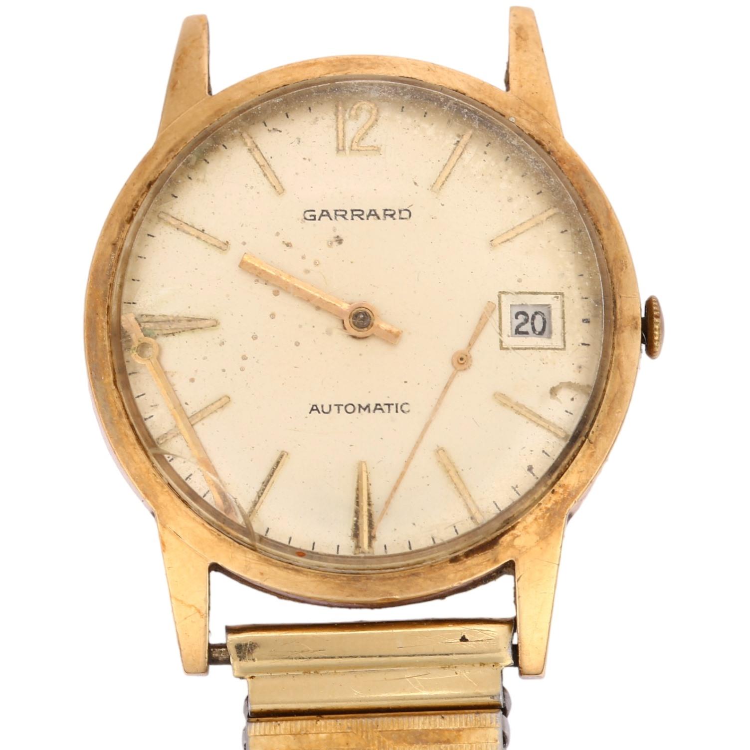 GARRARD - a 9ct gold automatic wristwatch, silvered dial with applied gilt baton hour markers and