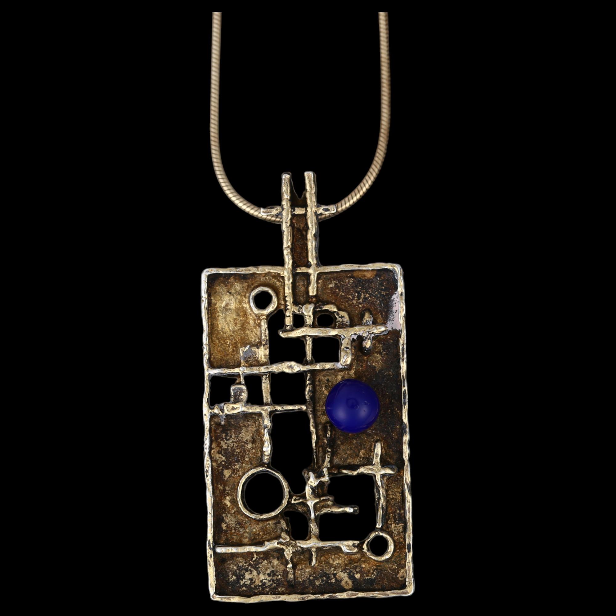 HERMANN SIERSBOL - a Danish brutalist gilded sterling silver and blue glass abstract pendant