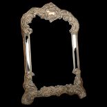 A large Edwardian silver-fronted dressing table mirror, William Comyns, London 1907, with relief