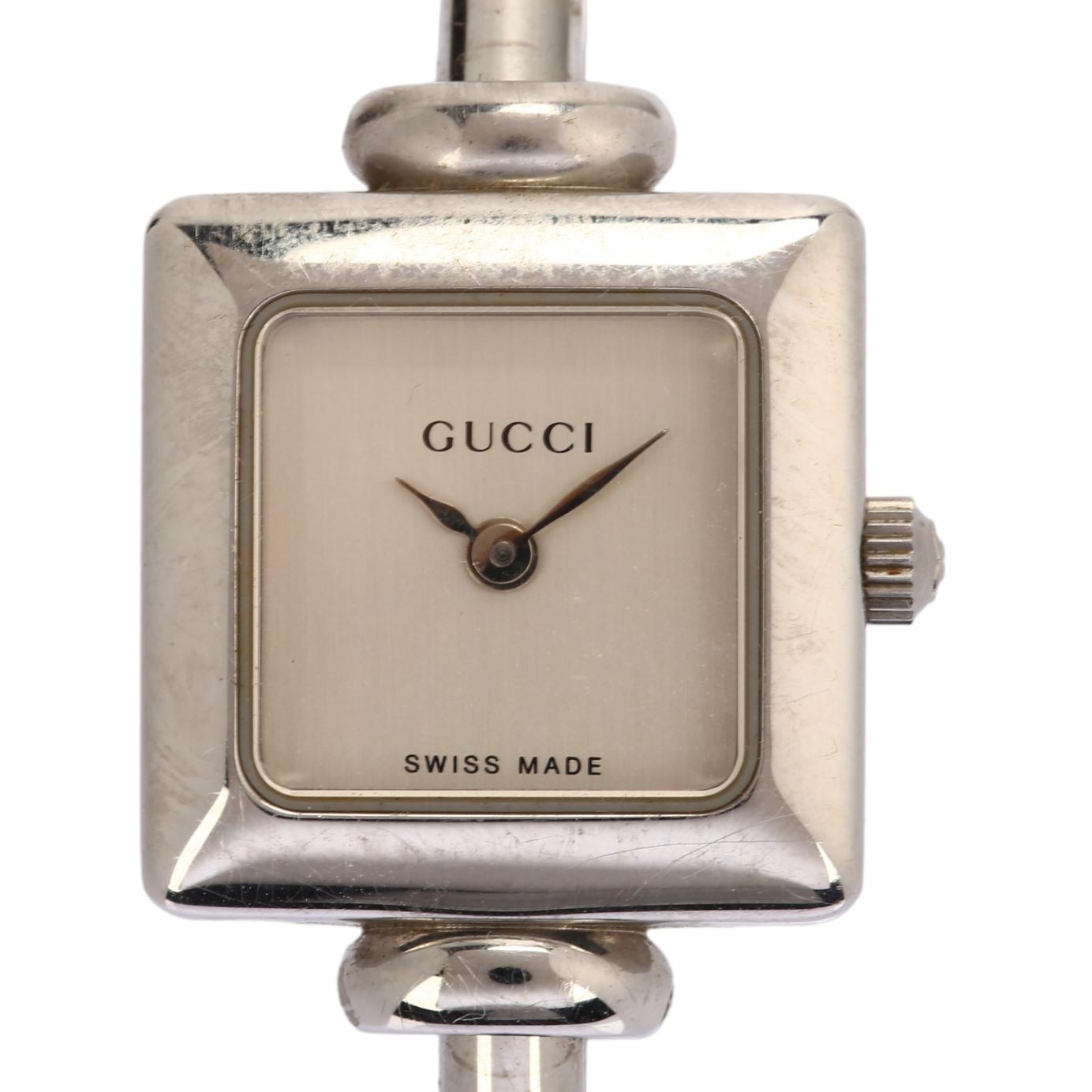 GUCCI - a lady's stainless steel 19L quartz bangle watch, circa 2000, square silvered dial with leaf