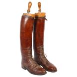 A pair of early 20th century brown leather military riding boots and trees, boot height 49cm approx,
