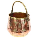 An Indian polished brass and copper swing-handled bucket, with applied brass-work decoration, height