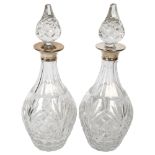 A pair of cut-glass decanters with silver collars, hallmarks for London 1970, H32cm Both in good