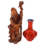 A carved hardwood figure of a sage with staff, 46cm, and a cinnabar vase of hexagonal form, with