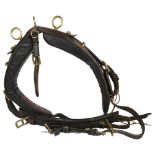An early 20th century leather and brass-mounted heavy horse collar, with straps