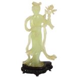 A jadeite figure of a Chinese lady holding flowers on stand, H26cm