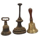 2 cast-iron doorstops, tallest 35cm, and a brass bell with turned wood handle, H29cm