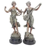 A pair of patinated spelter musician figures on turned wood base, H42cm Figure playing the lyre is