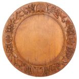 A 20th century turned wood bread board, with applied leaf and floral decoration, diameter 32cm There