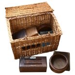 A wicker hamper containing wooden boxes and empty cutlery boxes