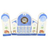 A Continental porcelain clock garniture, with printed Eastern scenes, clock height 31cm