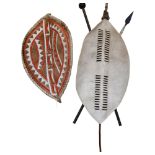 An African Zulu shield, shield length 90cm, overall 143cm, and an African Masai shield, length 80cm,