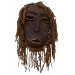 A large Marli carved wood and rope mask, L50cm