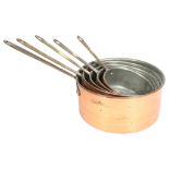 A graduated set of 5 copper and brass-handled saucepans