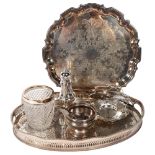 A silver plate on copper oval galleried tea tray, a circular engraved silver plated tea tray, a