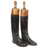 A pair of early 20th century black leather riding boots and trees, boot height 45cm, unknown size