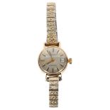 LONGINES - a lady's Longines automatic 9ct gold cased wristwatch with date aperture, with a plated