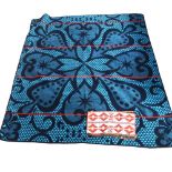 A Seanamarena, an African wool blanket with turquoise coloured symmetrical design, 155 x 165cm