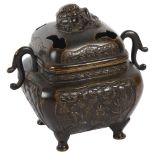 An Oriental embossed bronze censer with figure and foliate designs, on 4 feet, H11.5cm