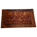 A Balinese wall plaque with allover relief carved ceremonial decoration, L75.5cm